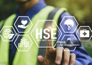 HSE - health safety environment concept.Construction inspector in uniform is checking industrial building and environment.Safe and standardized industry.